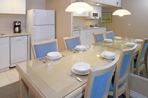 Fully equipped kitchen with spacious dining area.