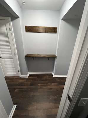 View from bedroom and entry table with coat hooks. 