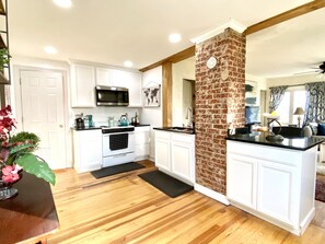 Open concept, kitchen, with beautiful black granite countertops.