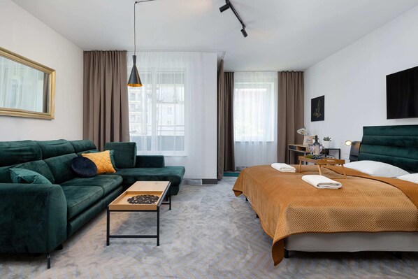 Elegant living room with a green sofa and stylish decor.