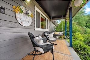 Front porch with swing and rocking chairs 