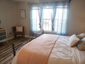 Master bedroom suite, king bed, attached bathroom with dual sink vanities.