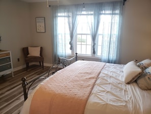 Master bedroom suite, king bed, attached bathroom with dual sink vanities.