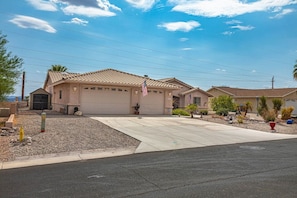 Front of home with garage and outdoor parking.