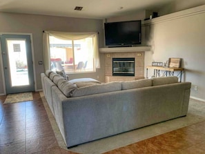 Living room with comfy couch and TV with basic cable and streaming apps.