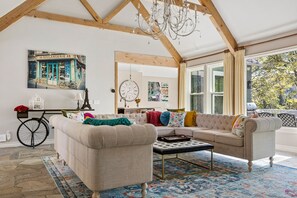 Upstairs Living Room, high ceilings w/ beams; fireplace, chandelier, seating 10