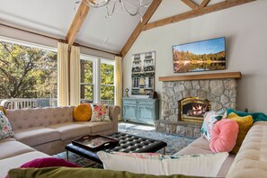 Upstairs Living Room, high ceilings w/ beams; fireplace, chandelier, seating 10
