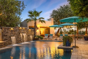 Beautiful Waterfall Features & Sheltering Umbrellas Near The Poolside.