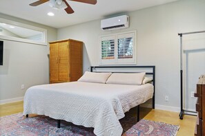 King size bed, hanging bar for clothes, & two dressers.