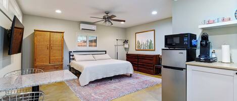 Main studio area includes king bed, tv, kitchenette & dining table.