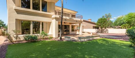 Backyard to lounge and play cornhole. Multiple seating areas.