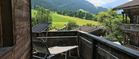 Sky, Property, Building, Furniture, Cloud, Mountain, Shade, Wood, Plant, Chair