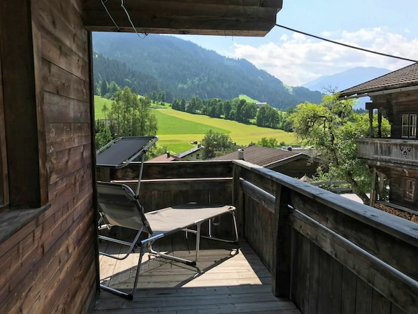 Sky, Property, Building, Furniture, Cloud, Mountain, Shade, Wood, Plant, Chair