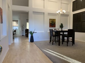 Front entry & view of formal dining area. Vaulted ceilings throughout the home. 