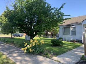 Beautiful flowers and cherry trees grace the landscape. 