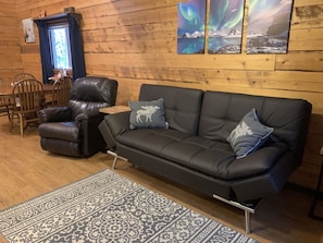 Living room (with futon that makes into a full size bed) and dining area