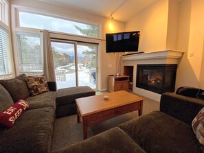 Enjoy the warm, open-concept living and dining area complete with a cozy gas fireplace