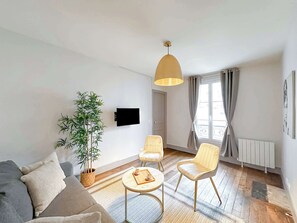 A brightness living room with a flat screen TV is the best place to relax after a walking day.
