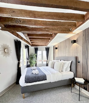 Spacious bedroom with a queen-size bed and ample storage