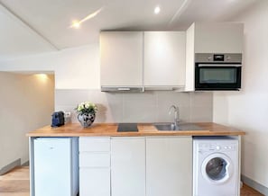 Kitchen complete with utensils and appliances for all your culinary needs.