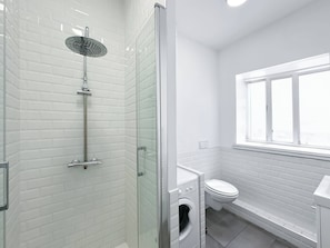 A brand new bathroom with shower, washer/dryer and towels for your stay