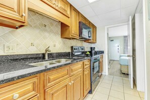 Stylish and modern kitchen equipped with all essentials, allowing you to prepare meals while enjoying the ocien view.