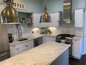 Well stocked and updated kitchen offering a 4 burner gas stove w/built in grill