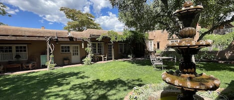 Fountain and view of portal. Mature Apricot tree and flower gardens. 