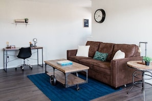 Living room equipped with family-friendly games and minimal work desk.