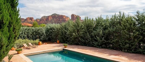 Escape the Desert sun and cool off in this Beautiful heatable swimming pool at Hot Tub is private with lush landscape all around