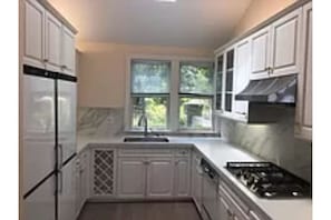 Galley kitchen with eating counter in front of photo