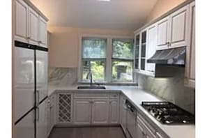 Galley kitchen with eating counter in front of photo