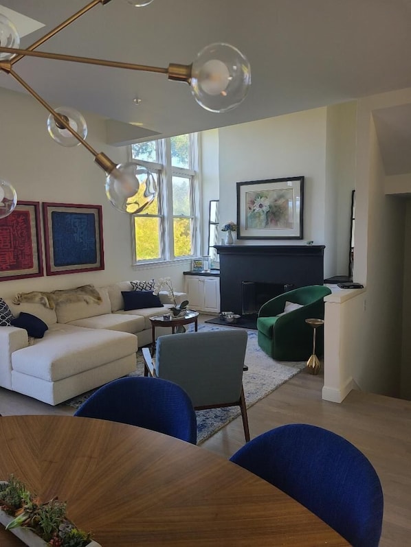 Living with gas fireplace...lots of sunlight with access to balcony with view