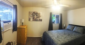 Bedroom w/ Queen Bed. Has window A/C, ceiling fan & closet.