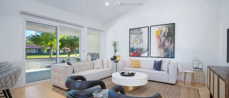 Living room opens up to golf course with smart TV and adjacent to kitchen.