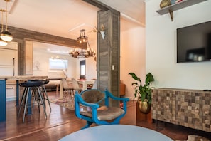 Living room with view of dining room, open kitchen and lounge area 