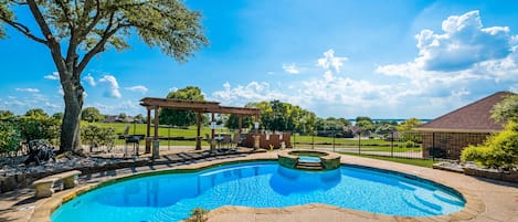 Backyard with heated pool, spa, grill, patio and outdoor dining.