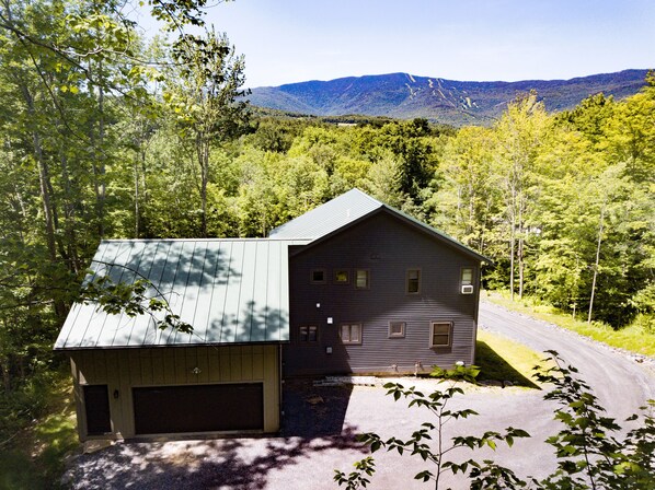 View of the property from the back - looking at the green mountains/ sugarbush