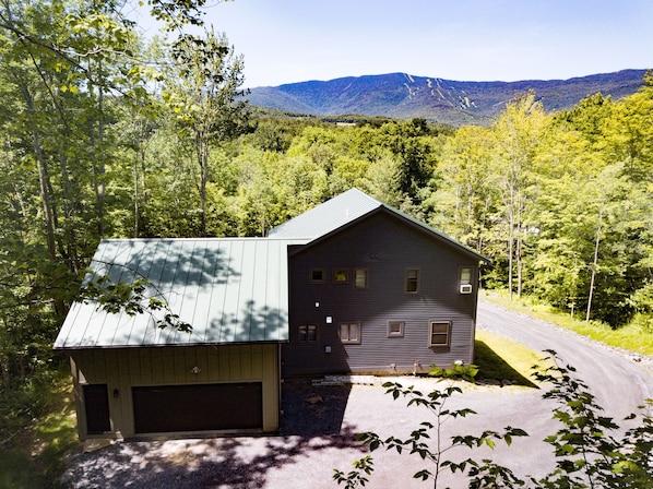 View of the property from the back - looking at the green mountains/ sugarbush