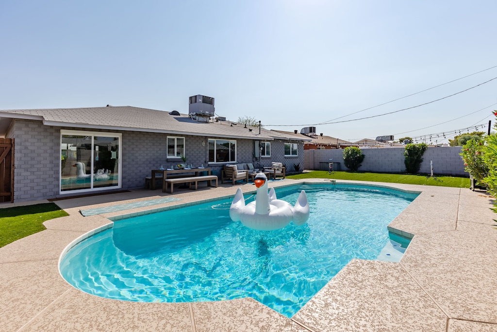 Private backyard with pool, dining area, yard games, grill and seating areas