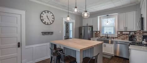 Roomy kitchen with center island and stainless appliances