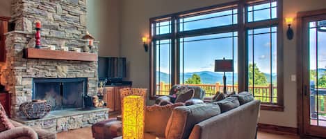 Living Area w/ Wood Fireplace, Vaulted Ceilings & Mountain Views