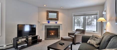 Bright open living room.  Comfortable seating while you enjoy the gas fireplace.