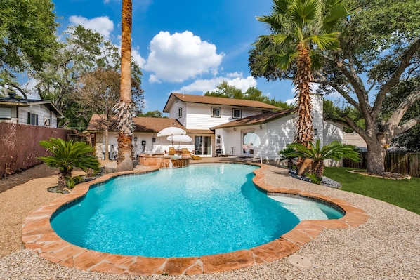 This amazing pool is heated by a 450,000 BTU gas heater! Don't want to wait for the pool? Crank the hot tub and relax in this backyard paradise no matter the season