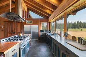 Fully-furnished gourmet kitchen looks out on Mt Rose and the golf course