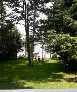 Yard leading to sandy beach.