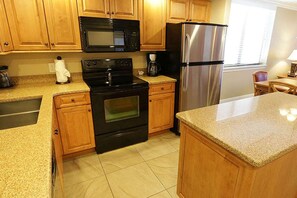 Kitchen comes with dishwasher, refrigerator, oven/stove, coffeemaker, dishware, and silverware.