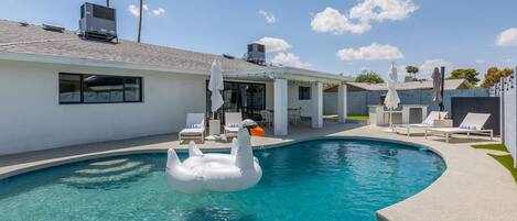 Private backyard with pool, built in grill, putting green and lounge areas