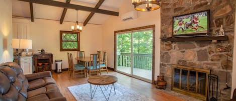 Great Room with Stone Wood-burning Fireplace, HD Smart TV, and Dining Area!