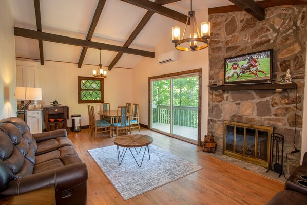 Great Room with Stone Wood-burning Fireplace, HD Smart TV, and Dining Area!